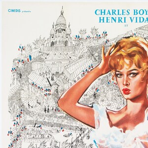May include: Vintage movie poster featuring a woman with blonde hair and red lipstick. The poster has a drawing of a city with the text "CHARLES BOYER HENRI VIDA" and "CINEDIS pr&eacute;sente". The background is a black and white illustration of a city.