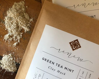 May include: A brown paper pouch with a white label that reads "renee GREEN TEA MINT Clay Mask REJUVENATING French Green Clay 1 OZ. SCOOP 1/2 TEASPOON AND MIX WITH WATER. WWW.UNEARTHMALEE.COM UNEARTH MALEE 1326 MONTE VISTA. STE 2 CLAREMONT CA 91784" and a small floral design in the top right corner.