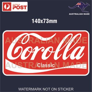 May include: Red and white sticker with the text "Corolla Classic" in a white cursive font. The sticker is 5.5 inches by 2.9 inches.