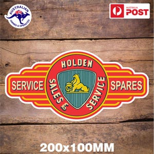 May include: A rectangular Holden Service & Spares sticker with a red, yellow, and white design. The sticker features the Holden logo, a yellow lion holding a globe, and the text "SERVICE SALES & SERVICE SPARES". The sticker measures 20cm x 10cm.