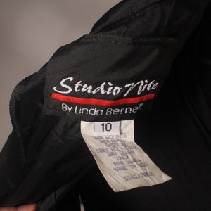 May include: Black Studio Nite by Linda Bernell dress with a size 10 tag. The tag includes care instructions and is made in the USA.