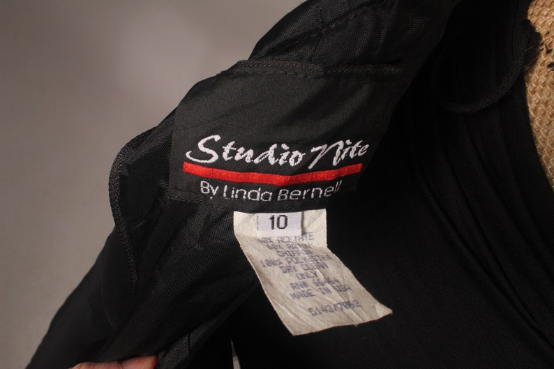May include: Black Studio Nite by Linda Bernell dress with a size 10 tag. The tag includes care instructions and is made in the USA.