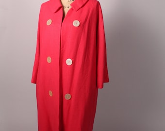 May include: A long, bright pink coat with a double breasted closure and large white buttons. The coat is on a mannequin.