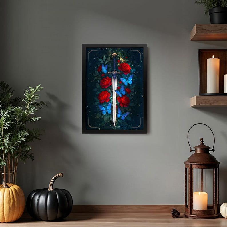 May include: Framed artwork featuring a sword surrounded by red roses and blue butterflies. The sword has a silver blade and a dark blue hilt. The background is a dark teal color, and the artwork is in a black frame.