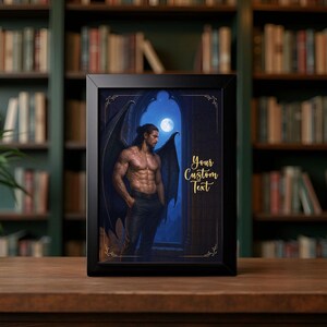 May include: A framed print featuring a muscular figure with dark wings, tattoos, and long hair, standing in a gothic archway under a full moon. The artwork is set against a dark blue background with the text "Your Custom Text" in gold.