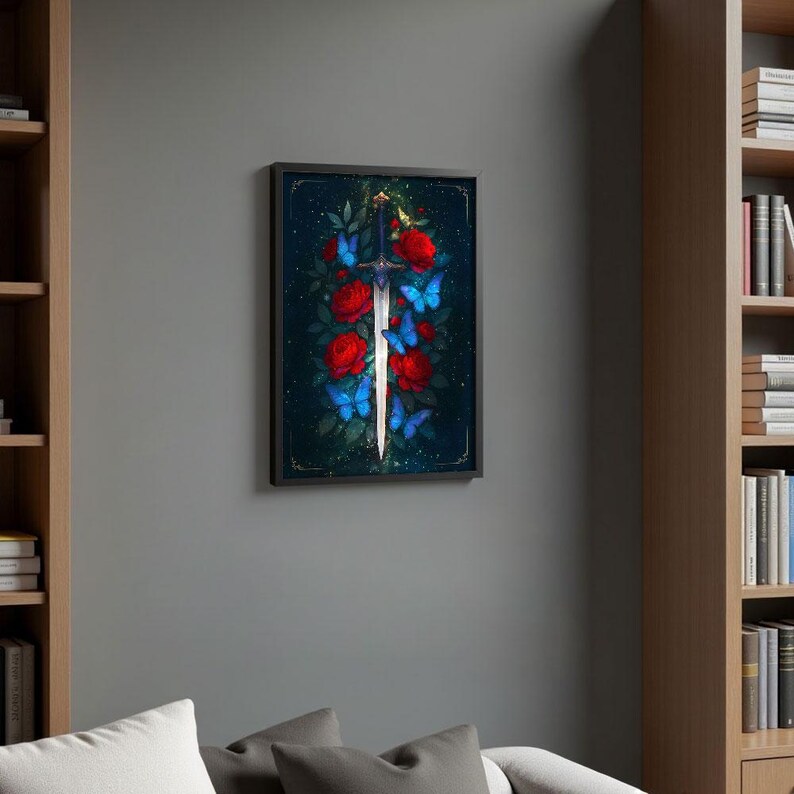 May include: Framed artwork featuring a silver sword with a red and blue floral design. The sword is centered, surrounded by red roses and blue butterflies against a dark background. The artwork is in a black frame.