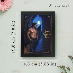 May include: Framed artwork featuring a muscular figure with dark wings, set against a moonlit archway. The black frame measures 14.8 cm (5.83 in) wide and 19.8 cm (7.8 in) tall. The text "Your Custom Text" is displayed in gold script.
