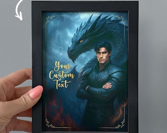 May include: Black framed fantasy art print featuring a man in armor with a dragon behind him. The artwork has a blue and gold color scheme. The text "Your Custom Text" is displayed in gold script. The image is held by a person.