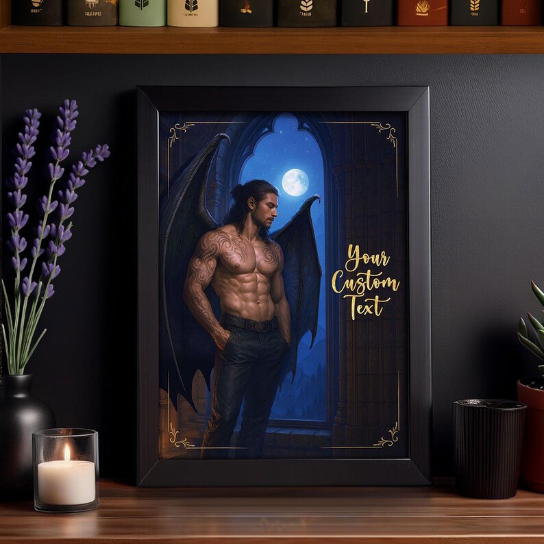May include: Framed art print featuring a muscular man with dark wings, tattoos, and black pants, standing in front of a moonlit window. The text "Your Custom Text" is displayed in gold script. The frame is black.