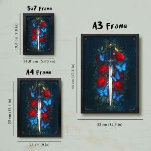 May include: Three framed art prints featuring a fantasy design. The artwork depicts a sword surrounded by red roses and blue butterflies. The frames are labeled 5x7, A4, and A3, with dimensions of 14.8 cm x 19.8 cm, 23 cm x 32 cm, and 32 cm x 44 cm.
