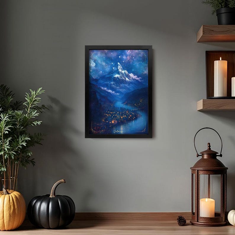 May include: A framed art print depicts a mountain landscape under a starry night sky. The artwork features a river winding through a valley with a town, all rendered in shades of blue and purple. The print is in a black frame.