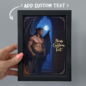 May include: Black framed art print featuring a muscular man with dark wings, standing in front of a moonlit window. The print includes the text "ADD CUSTOM TEXT" and "Your Custom Text" in gold lettering.