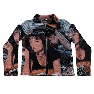May include: A tapestry jacket featuring a repeating image of a woman with black hair and a black top. The jacket has a zipper closure and a collared neckline. The color palette includes black, brown, and gray.