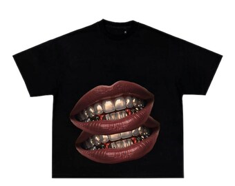 May include: Black t-shirt with a graphic of two sets of lips with gold teeth.