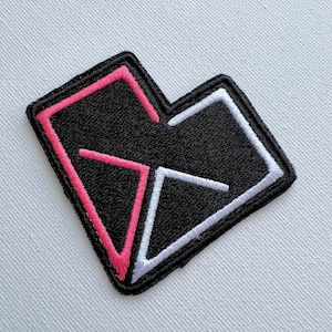 May include: Black embroidered patch in the shape of a heart with pink and white stitching.