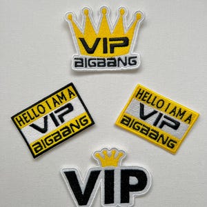 May include: A set of embroidered patches with the text "VIP" and "BIGBANG". The patches feature a yellow crown design, and the phrase "HELLO I AM A VIP BIGBANG". The patches are in black, white, and yellow.