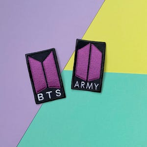 May include: Two black fabric patches with a purple stylized logo and white text. The left patch says "BTS" and the right patch says "ARMY".