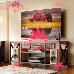 May include: A black metal TV stand with a wood top and two shelves. The stand has an X-shaped design on the front and a wire mesh back. There are two speakers on the shelves, one on each side of the stand. The stand is in front of a wall with a large flat screen TV displaying a picture of a rhinoceros in a lake.