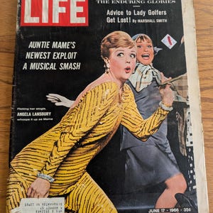 May include: A vintage LIFE magazine cover from June 17, 1966, featuring Angela Lansbury in a yellow sequined outfit. The cover also includes the text "Auntie Mame's Newest Exploit A Musical Smash" and "Advice to Lady Golfers Get Lost!"