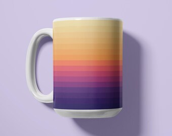 May include: A ceramic mug featuring a horizontal gradient pattern that transitions from a pale yellow at the top through shades of orange and pink to a deep purple at the base. The mug has a white handle and a white interior rim.