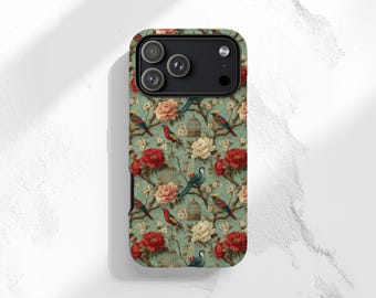 May include: A smartphone case featuring a repeating pattern on a sage green background. The design includes red and white blooming flowers, brown tree branches, small birds with red and blue plumage, and miniature birdcages throughout the print.