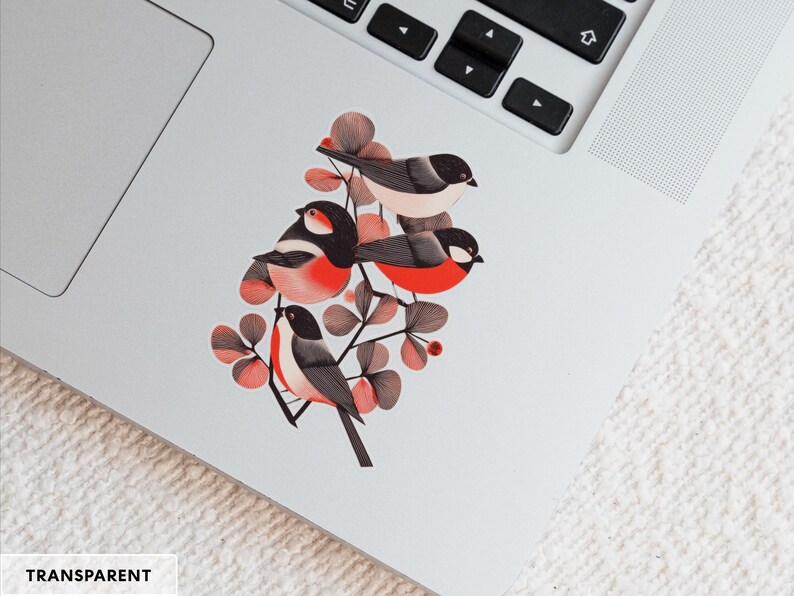 A beautiful and minimal illustration of four finches perched in a tree. Design is black, red and cream, printed on a kiss-cut vinyl sticker with a transparent border. Sticker is shown on an open silver laptop, next to the track pad.