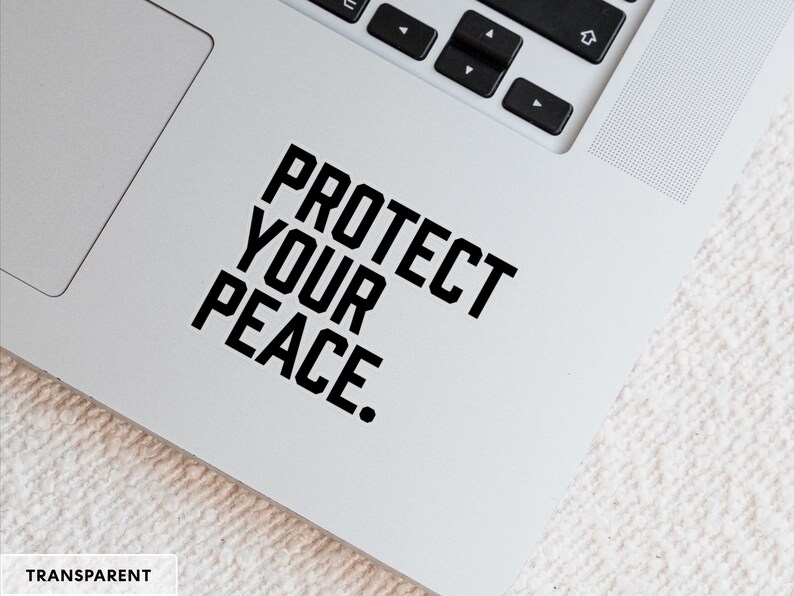 A bold typographic design reading PROTECT YOUR PEACE. Design is printed on a kiss-cut vinyl sticker with a transparent border. Sticker is shown on an open silver laptop, next to the track pad.