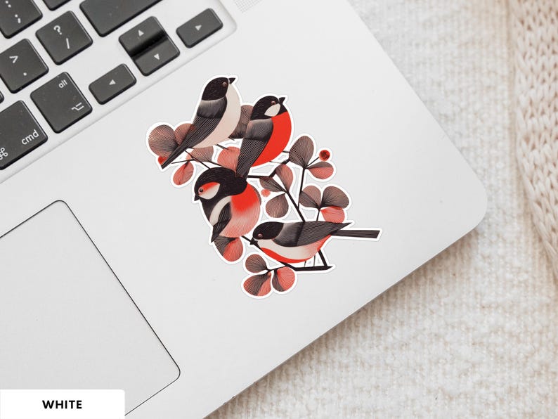 A beautiful and minimal illustration of four finches perched in a tree. Design is black, red and cream, printed on a kiss-cut vinyl sticker with a white border. Sticker is shown on an open silver laptop, next to the track pad.