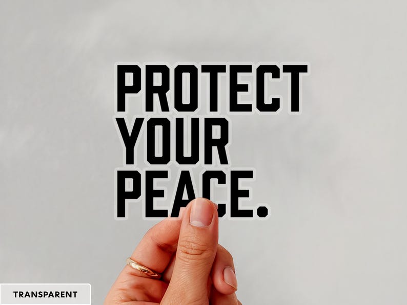 A bold typographic design reading PROTECT YOUR PEACE. Design is printed on a kiss-cut vinyl sticker with a transparent border. Sticker is being held by a single hand on a neutral, light grey background.