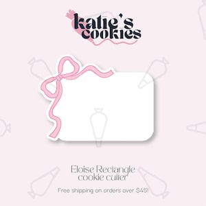 May include: A white rectangle cookie cutter with a pink bow design. The text "Katie's Cookies" is at the top, and "Eloise Rectangle cookie cutter" is at the bottom. The background is light pink with a pattern of piping bags.