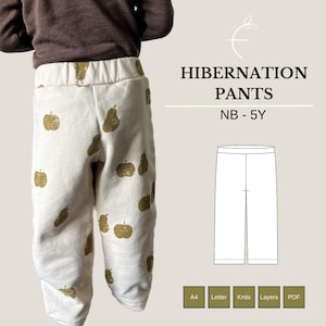 May include: A white pair of pants with a brown pear and apple print. The pants are called "Hibernation Pants" and are available in sizes NB - 5Y.
