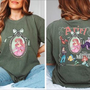 A woman wearing a green t-shirt with a Disney character design on the front and a back view of the same design.