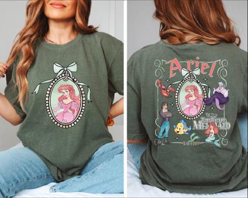 A woman wearing a green t-shirt with a Disney character design on the front and a back view of the same design.