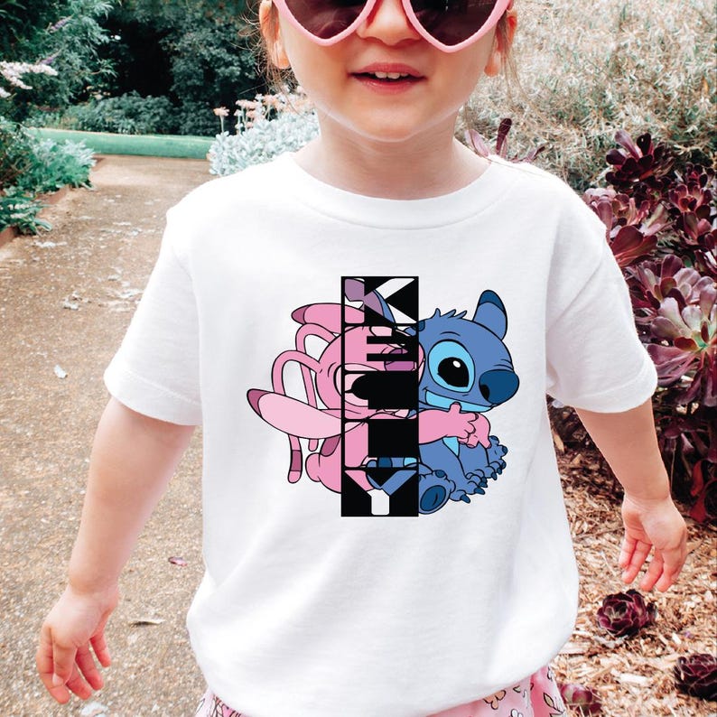 a little girl wearing sunglasses and a t - shirt
