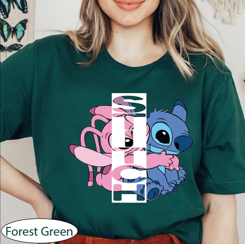 a woman wearing a forest green tshirt with an image of a cartoon character