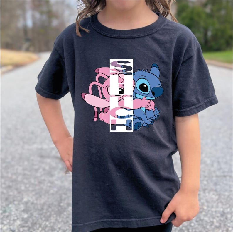 a little girl standing in the middle of a road