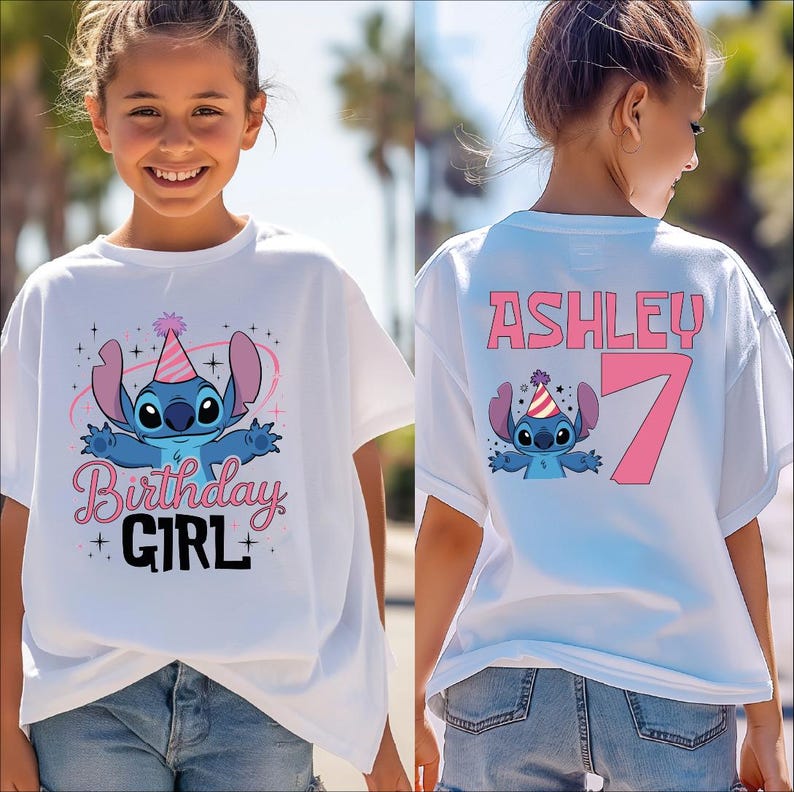 A young girl wearing a white t-shirt with a birthday party design and the name "Ashley" printed on it.