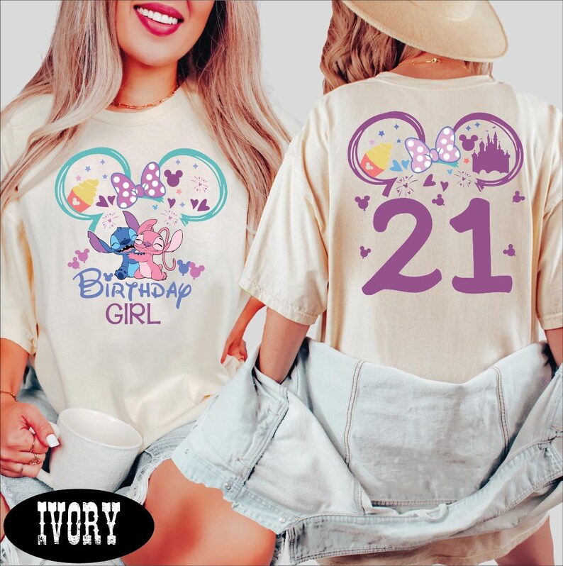 A woman wearing a white t-shirt with a birthday design and the number 21 on the back, along with a denim jacket.