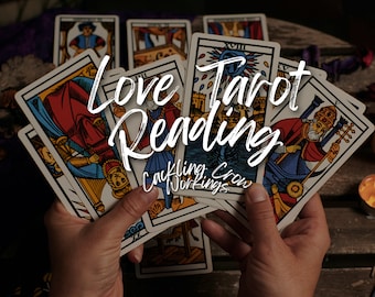 May include: A person holding a fan of tarot cards, with the text "Love Tarot Reading" and "Cackling Crow Workings" overlaid. The cards feature colorful illustrations and are arranged against a wooden surface, with a soft, warm light.