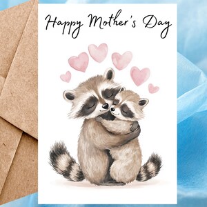 Carte de fête des mères heureuse de ratons laveurs mignons, carte de voeux aquarelle, carte de fête des mères animale faite main pour maman avec coeurs et enveloppe autocollante