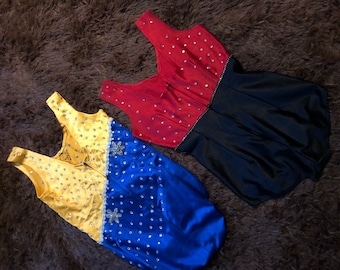 May include: Two leotards with rhinestones. One is red and black, the other is yellow, blue, and white.