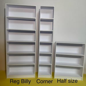May include: Three white bookshelves of different sizes. The largest bookshelf is labeled "Reg Billy", the middle bookshelf is labeled "Corner", and the smallest bookshelf is labeled "Half size".