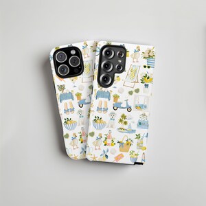 May include: Two white phone cases with a repeating pattern of summer-themed illustrations. The design includes ducks, lemons, beach chairs, scooters, and floral arrangements in shades of blue, yellow, and white.