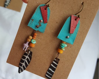 Unmatched turquoise roadtrip earrings with turquoise stone, wood beads and black feather