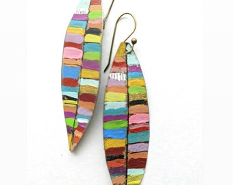 May include: A pair of handcrafted, colorful earrings. Each earring is a long, leaf-like shape, painted with horizontal stripes of various colors including pink, yellow, green, and blue. The earrings have brass-colored ear wires.