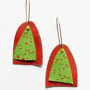 Christmas tree earrings on red arch