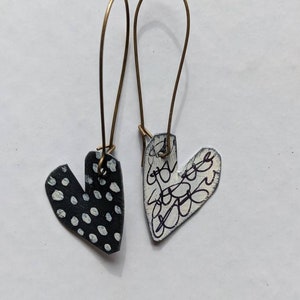 black and white unmatched painted tin hearts