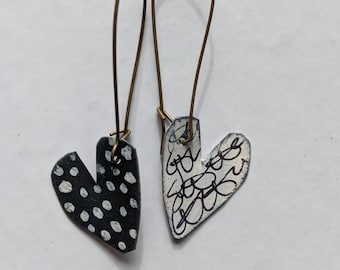 black and white unmatched painted tin hearts