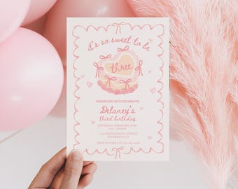 May include: Pink birthday invitation with a pink and white heart design. The text reads "It's so sweet to be three" and includes details for Delaney's third birthday party.