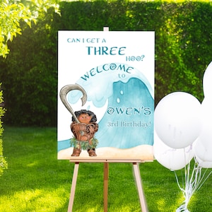May include: A welcome sign for a third birthday party. The sign features a cartoon character holding a hook, with the text "CAN I GET A THREE HOO? WELCOME to @OWEN'S 3rd Birthday!" on a white background. The sign is on an easel.